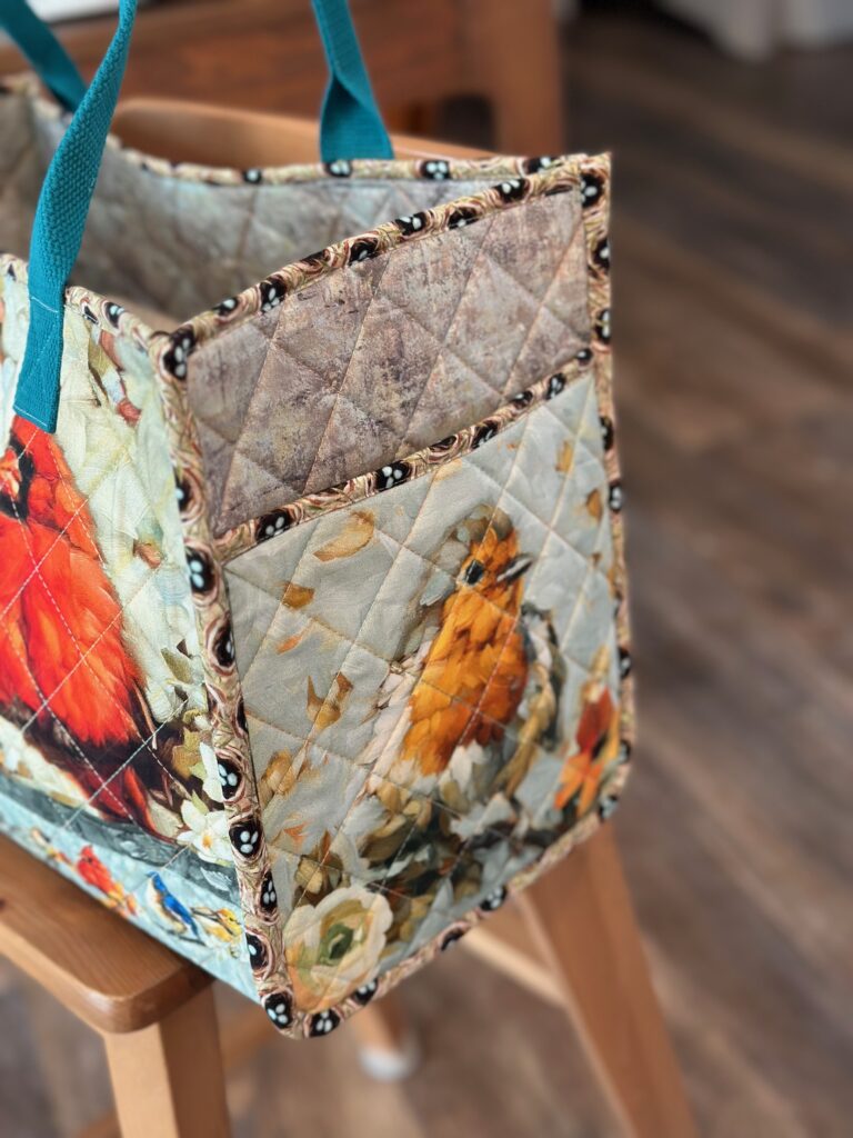 bird motif on pocket of tote