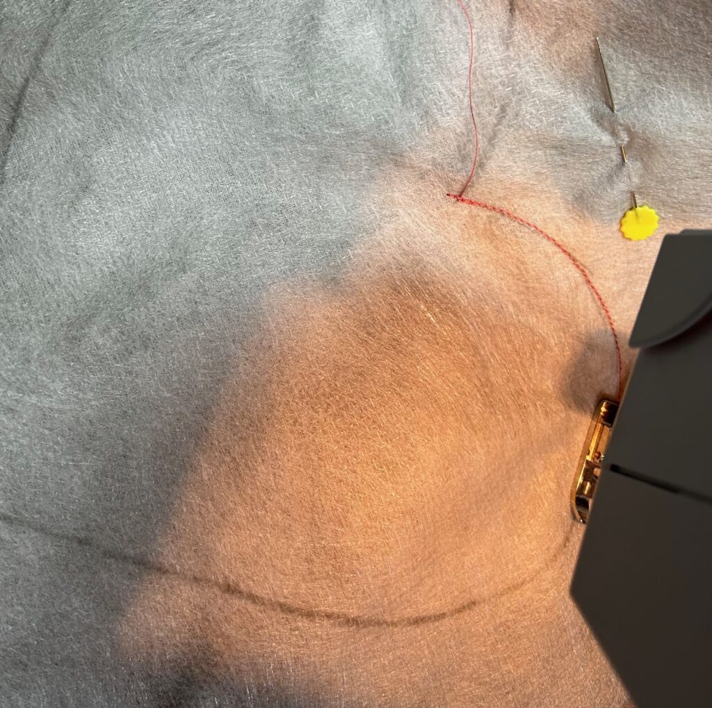 stitching along heart outline for pillow