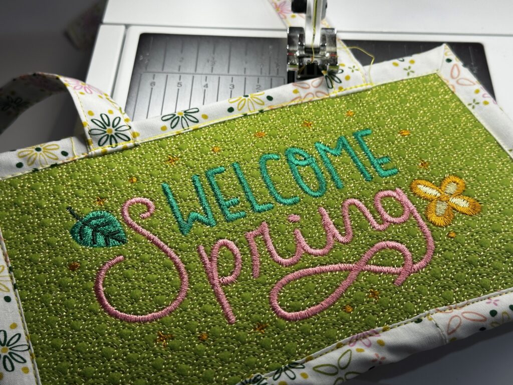 finished welcome sign on sewing machine bed