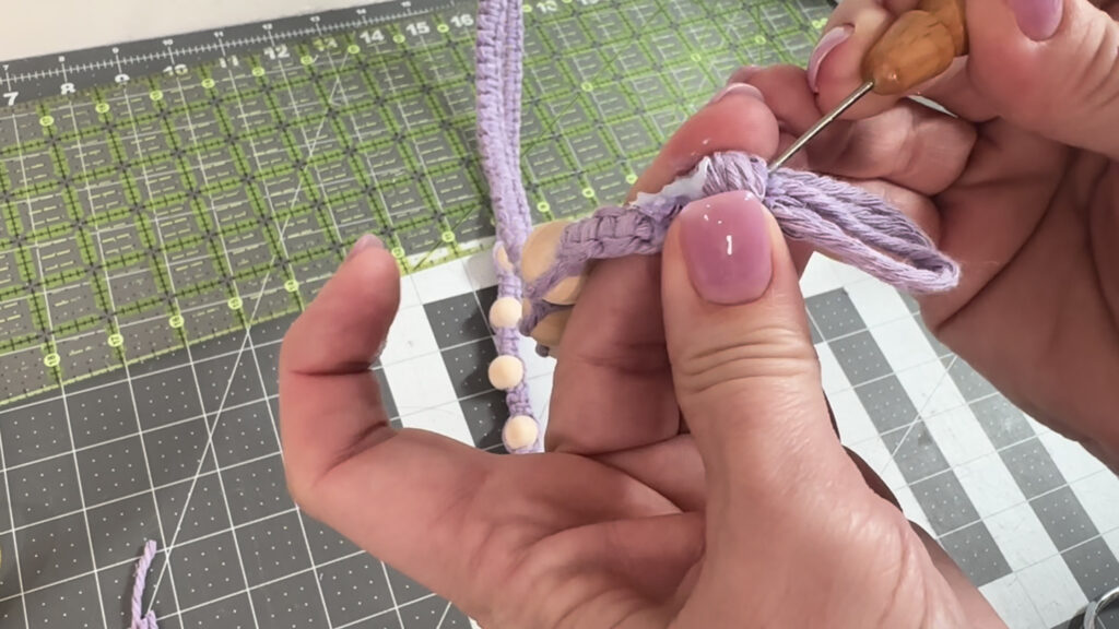 pushing cord ends into knot
