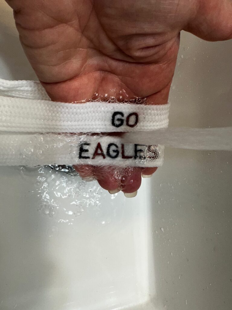 rinsing away Stick 'n Stitch from shoelaces