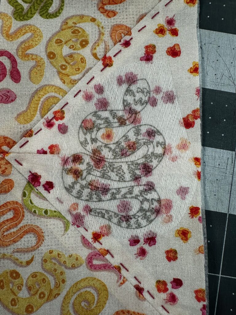 Stick 'n Stitch Transfer with snake design placed on bookmark