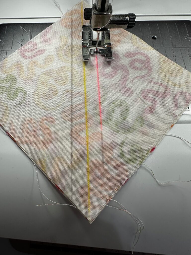 stitching along lines to make HSTs