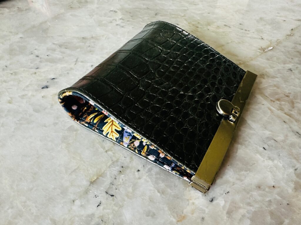 frame coin purse closed on table