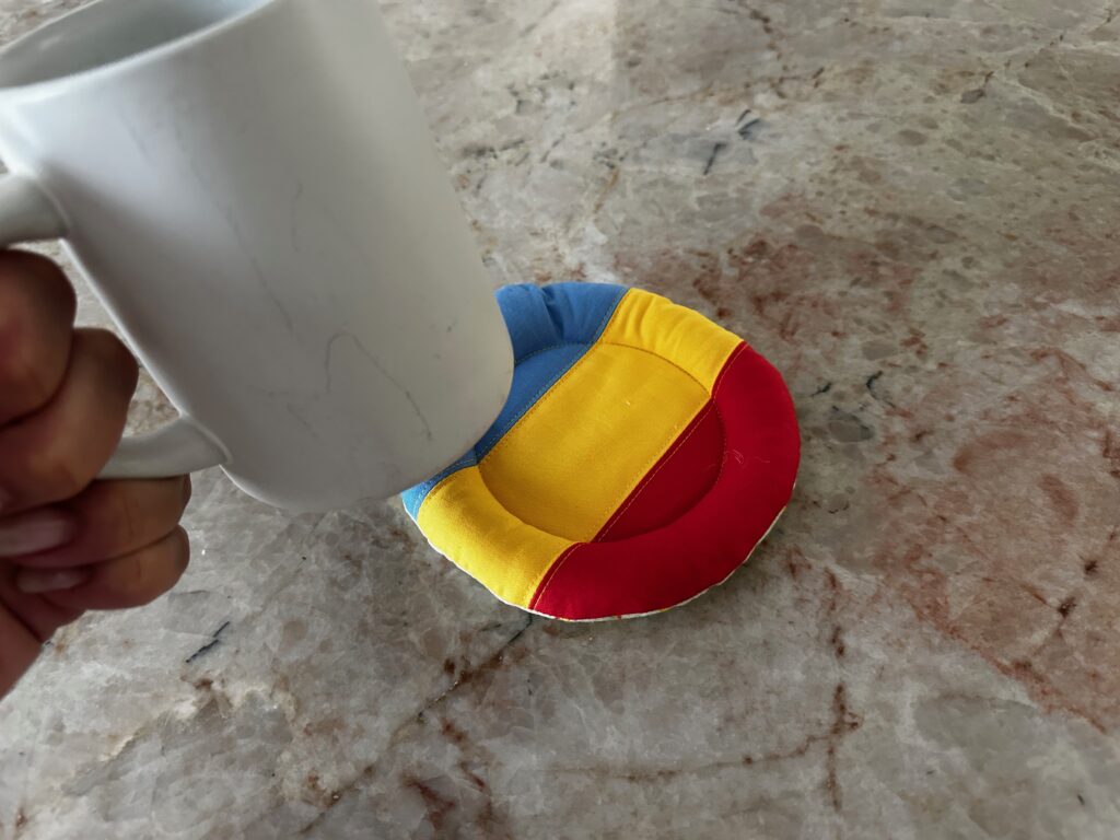 placing coffee mug onto mug pillow