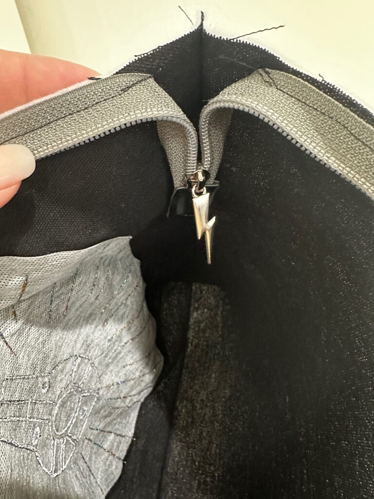 pushing zipper end inside pouch