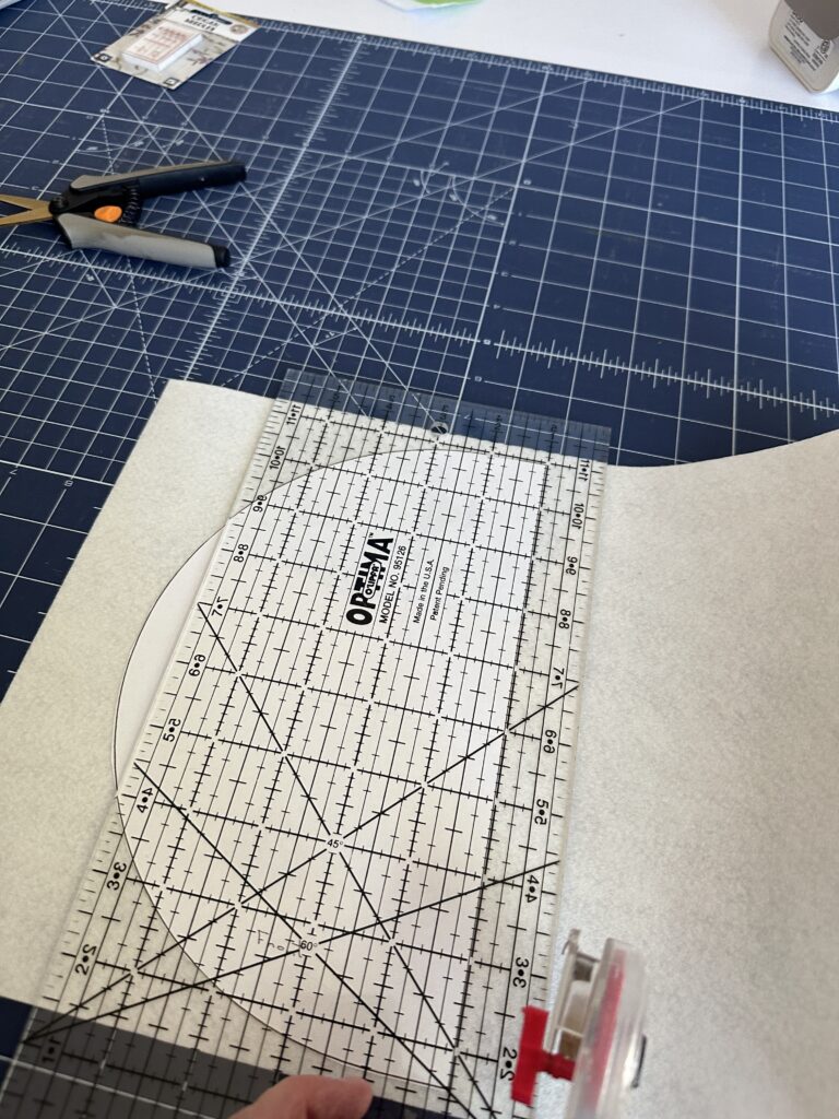 cutting half circles from white Felty for Bunting