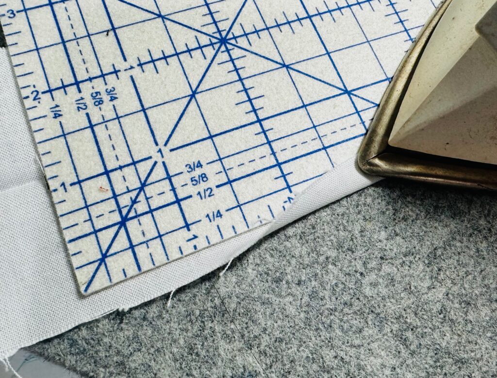 pressing long edges of casing 1/4" to wrong side
