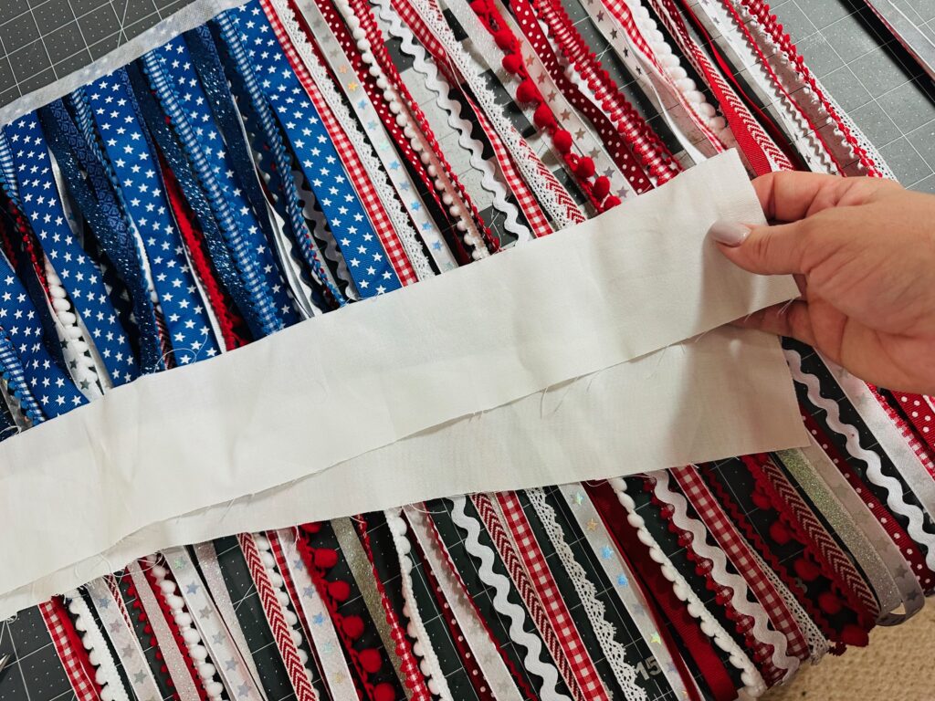 white fabric for casing over the top of ribbon flag