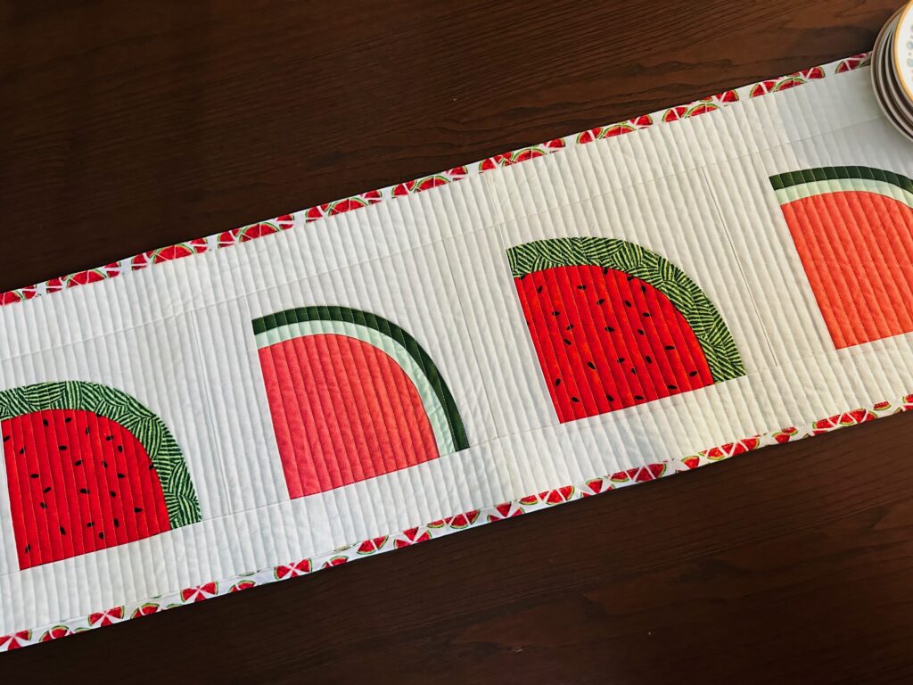 Watermelon Table Runner on dark wood table