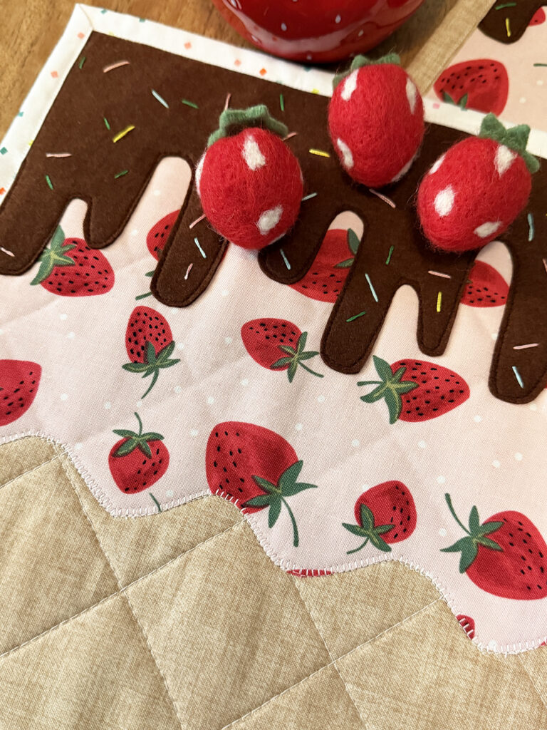 stitching on fudge drips on placemat