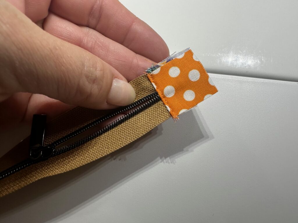 zipper tabs topstitched