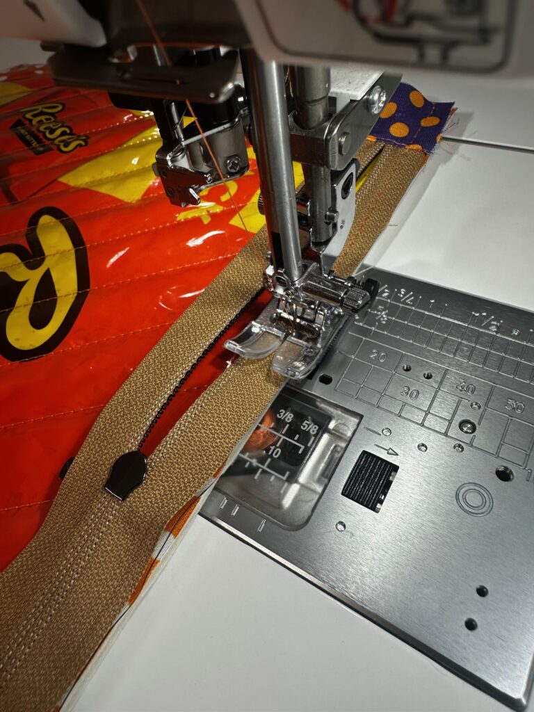 stitching zipper to exterior front of candy pouch