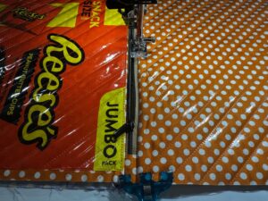 applying zipper to exterior back of candy pouch